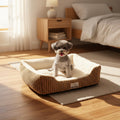 Dog sitting on a beige pet bed with a white background